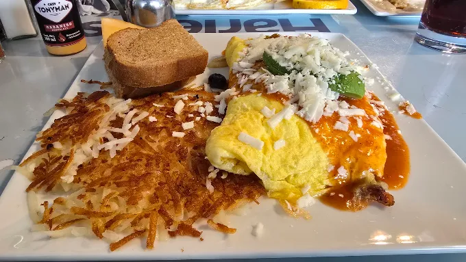 Omelette with ranchero sauce, cotija cheese, hash browns and wheat toast